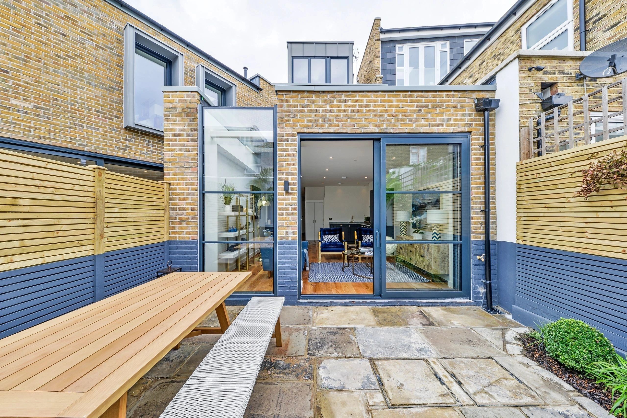 Blue-framed aluminium doors and windows in a contemporary courtyard extension, Victor Road